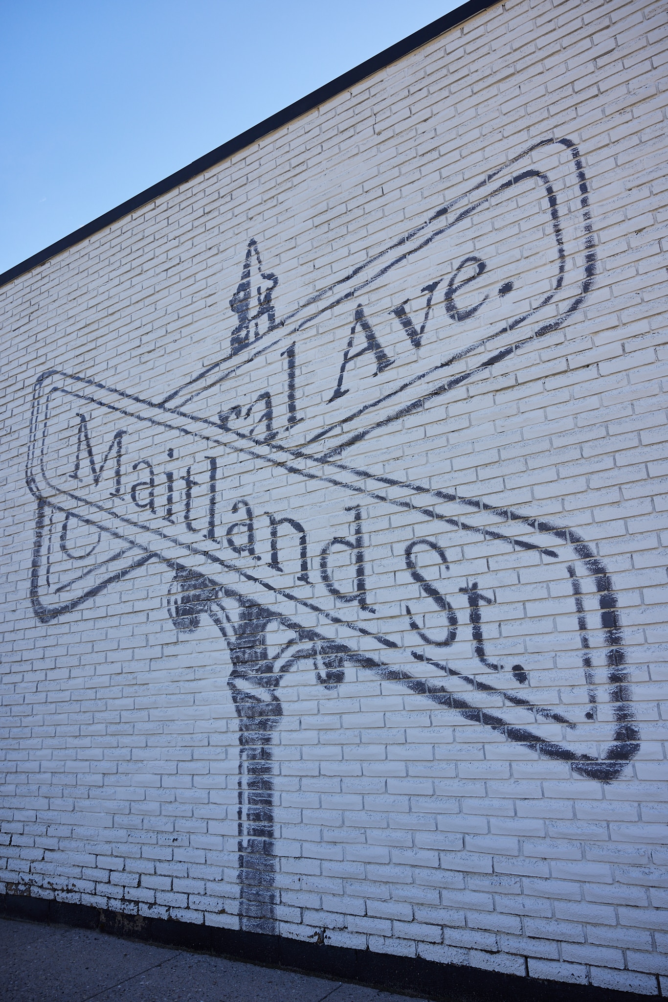 An image of a wall mural showing the two main street signs (Central Ave. & Maitland St.) across from the Ford Keast LLP office.