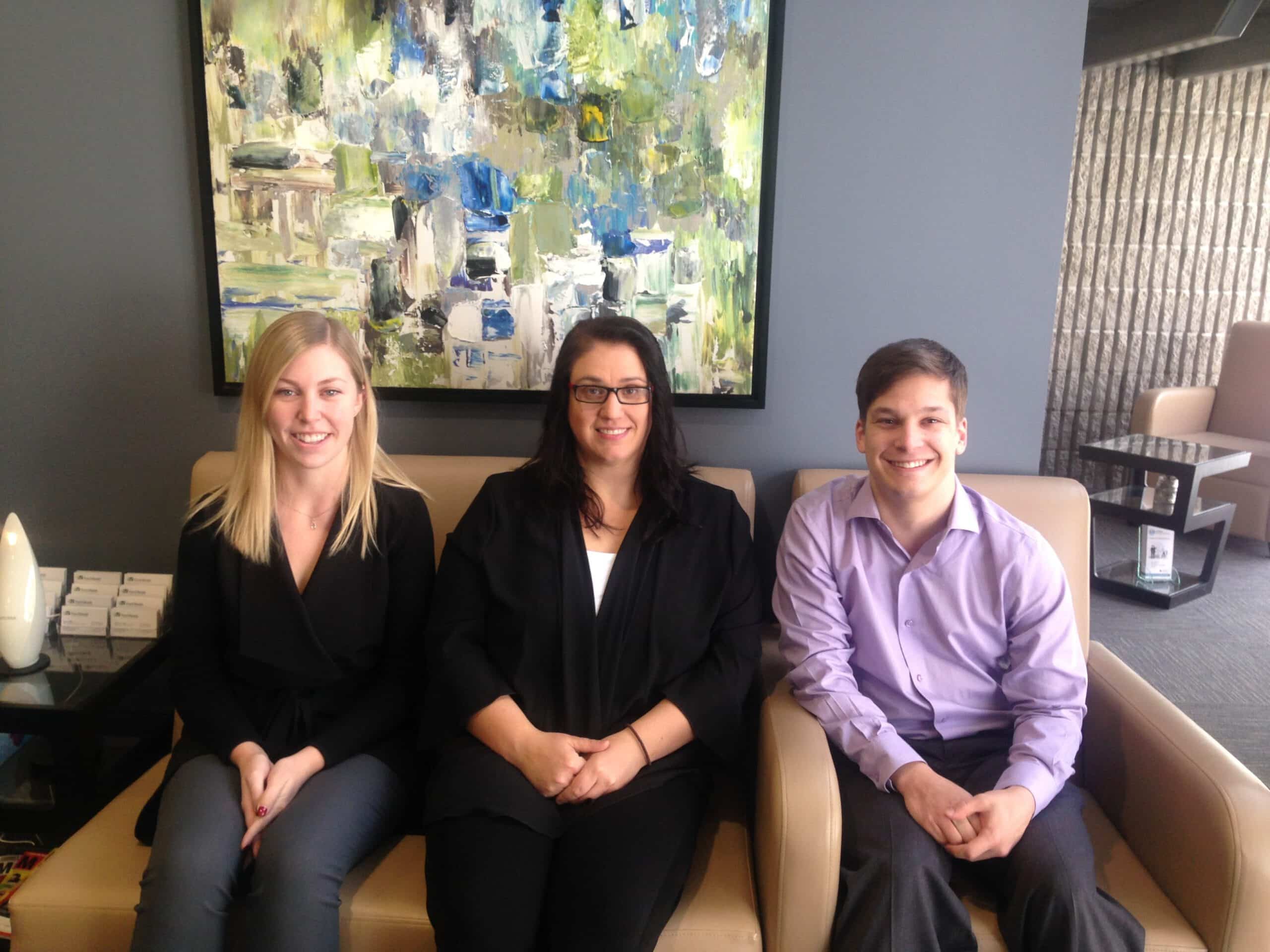 An image of three Ford Keast LLP staff members sitting together in the reception area of the office