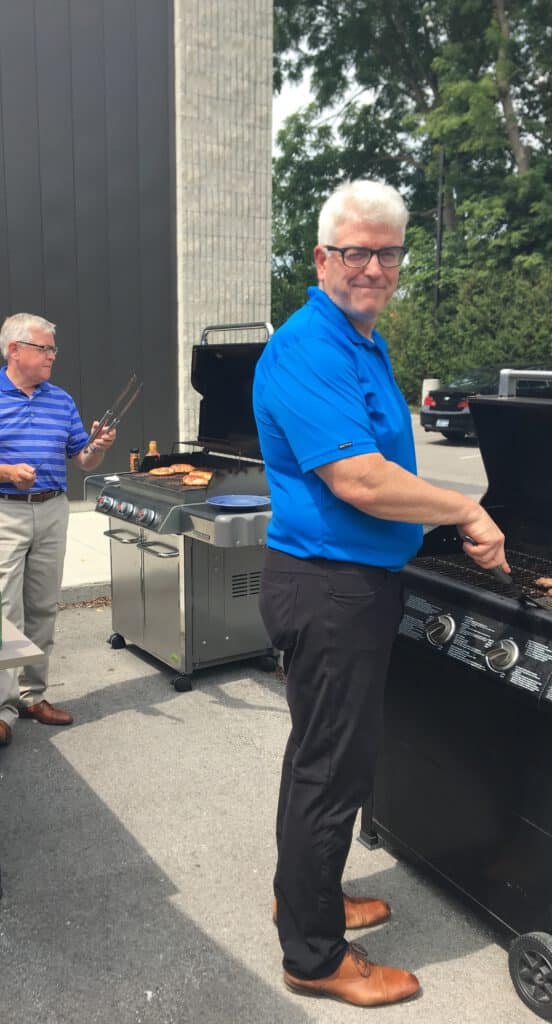 Two staff members working the BBQ grill