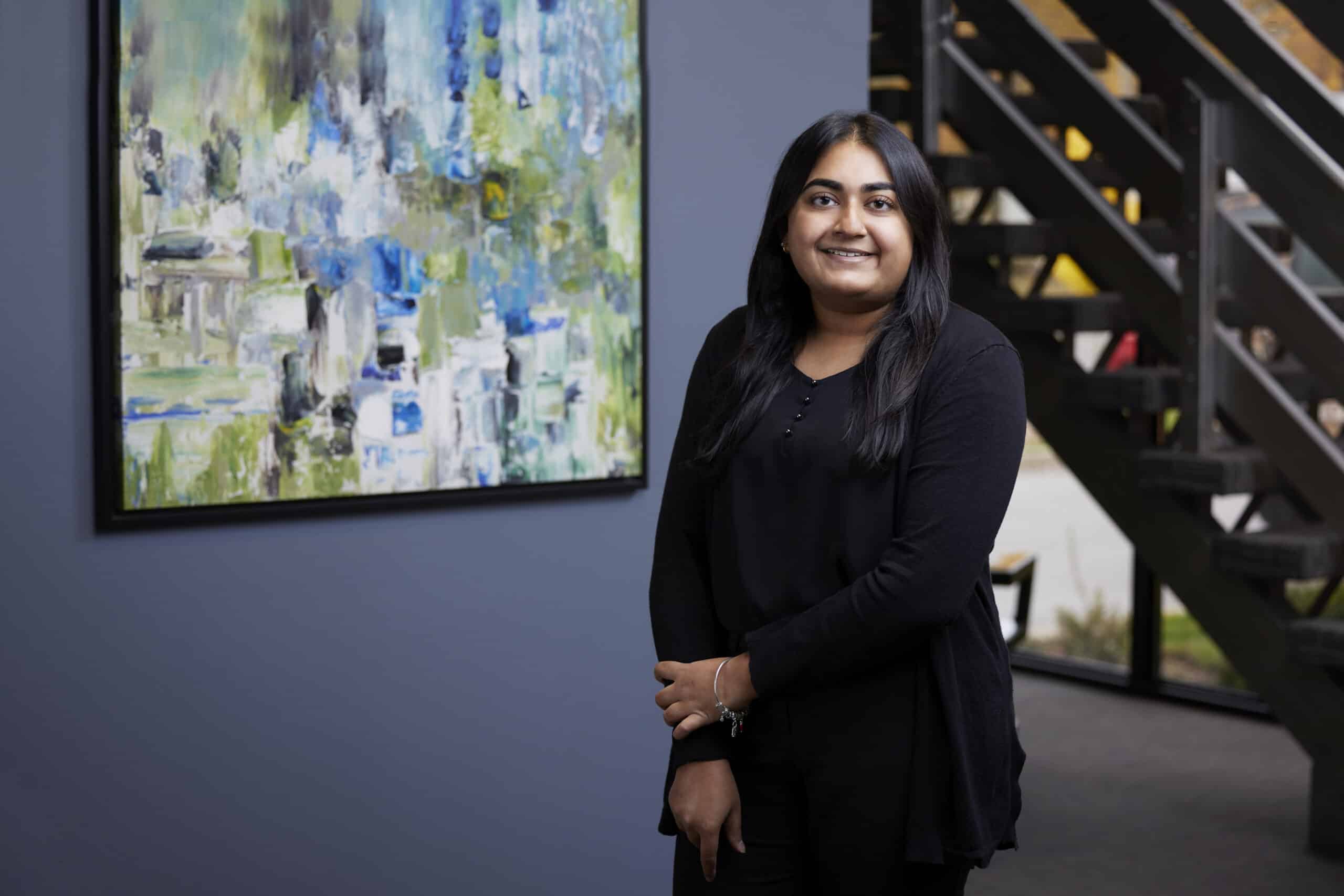 An image of Amrita Gupta in the lobby of the Ford Keast LLP London office.
