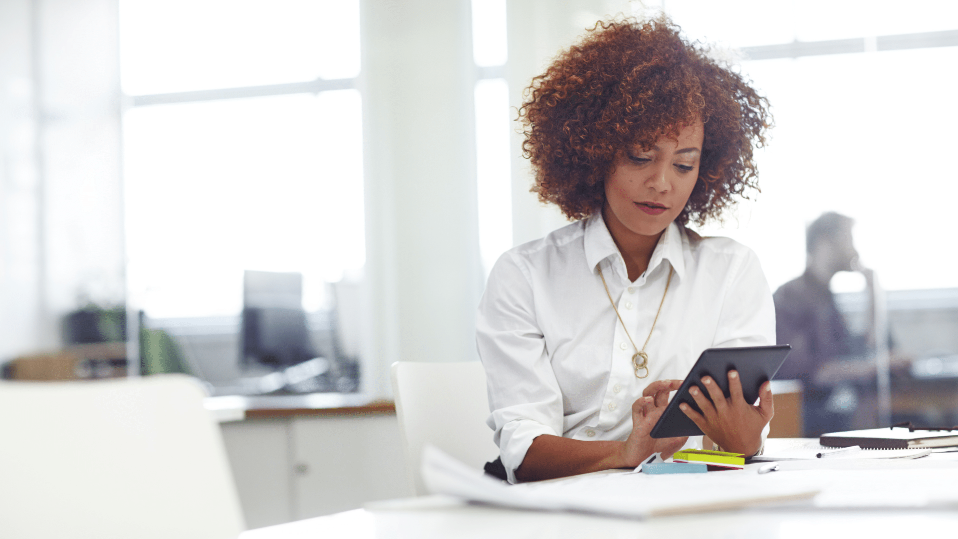 An image of an entrepreneur who is deciding whether to set up a holding company for her small business.