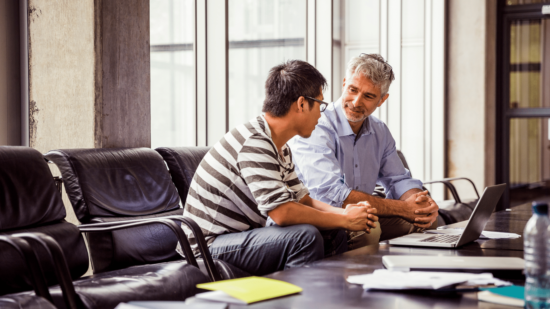 An image of a small business owner chatting with their local London accountant to discuss cutting costs.