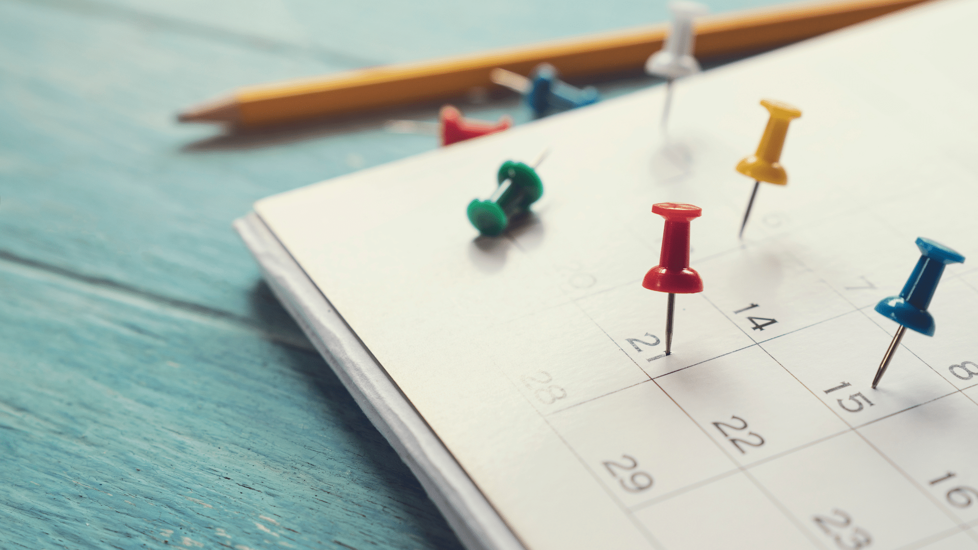 An image of a calendar with pins in it.