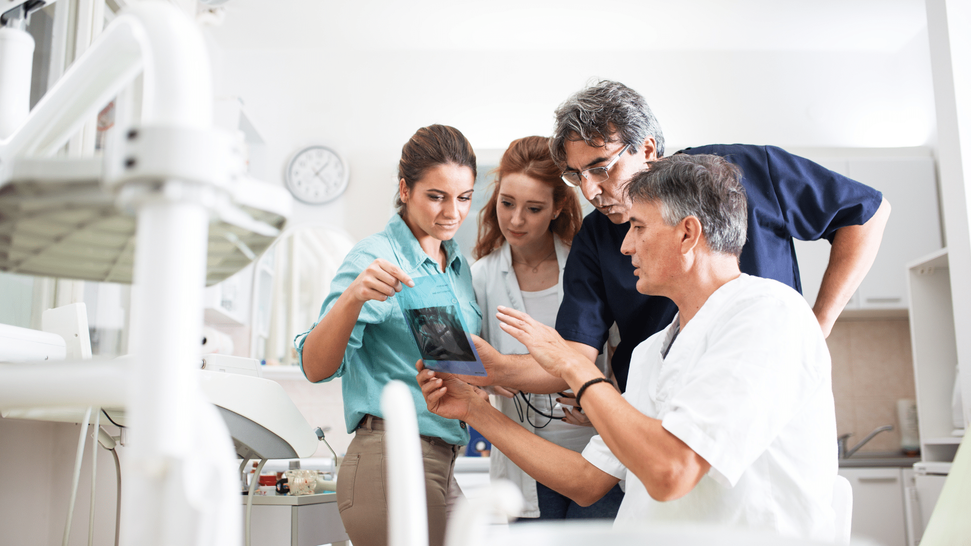 An image of a dental team reviewing a file together.