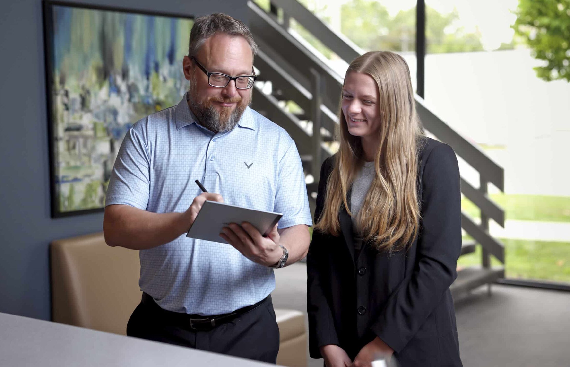 An image of two staff members chatting in the Ford Keast LLP lobby in London Ontario