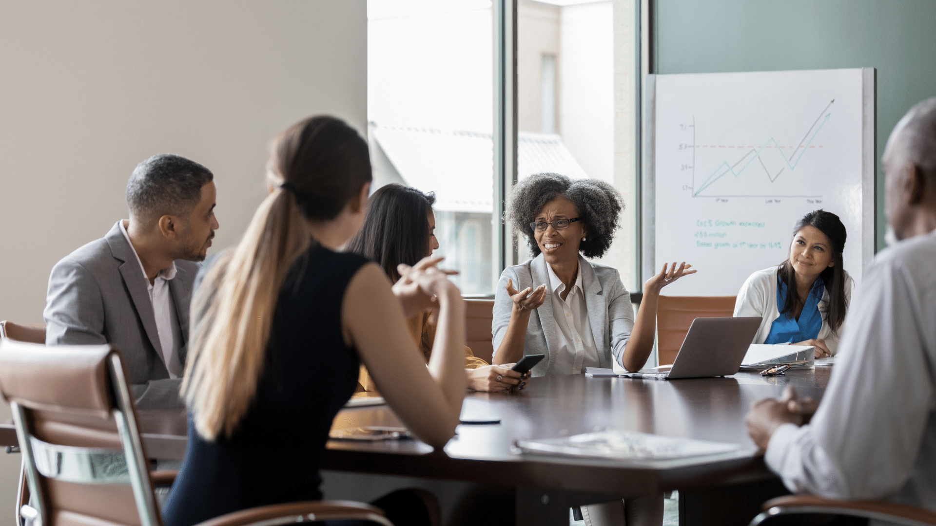 An image of a small professional services firm that is meeting to discuss profitability