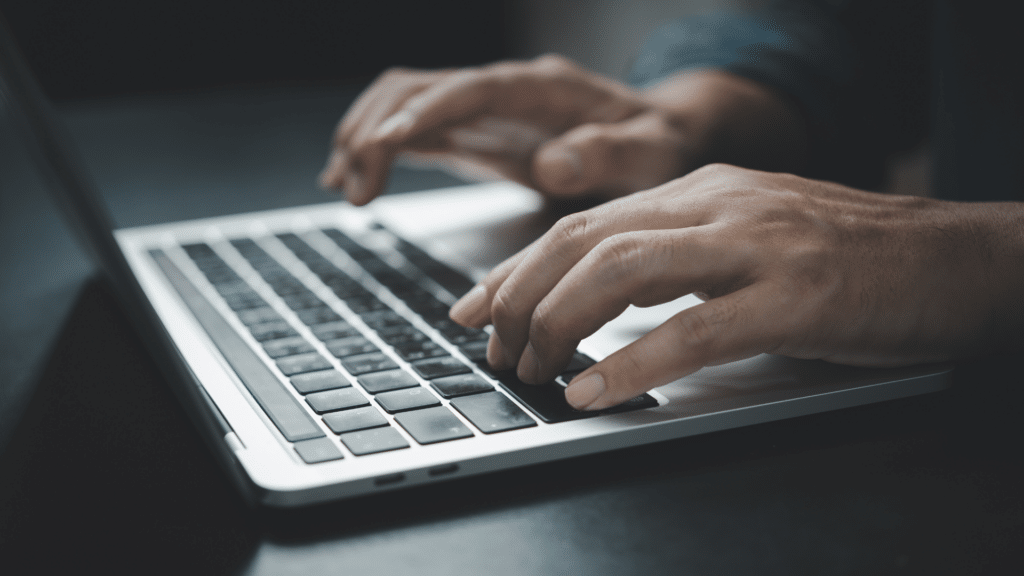 An image of someone working on their laptop making sure that their business is set up to receive online mail from the CRA.