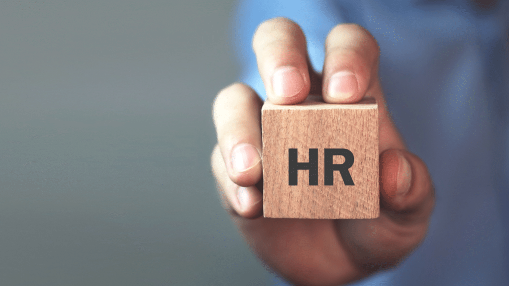 An image of a business person holding a HR Support block
