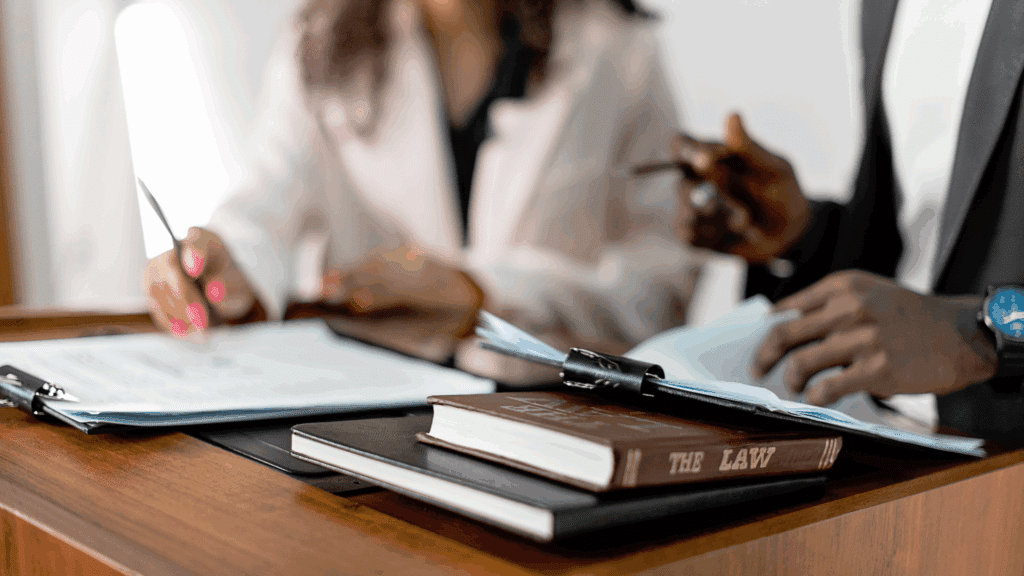An image of two small business owners who are reviewing the 2025-2026 Employment Law Updates Employers Should Know