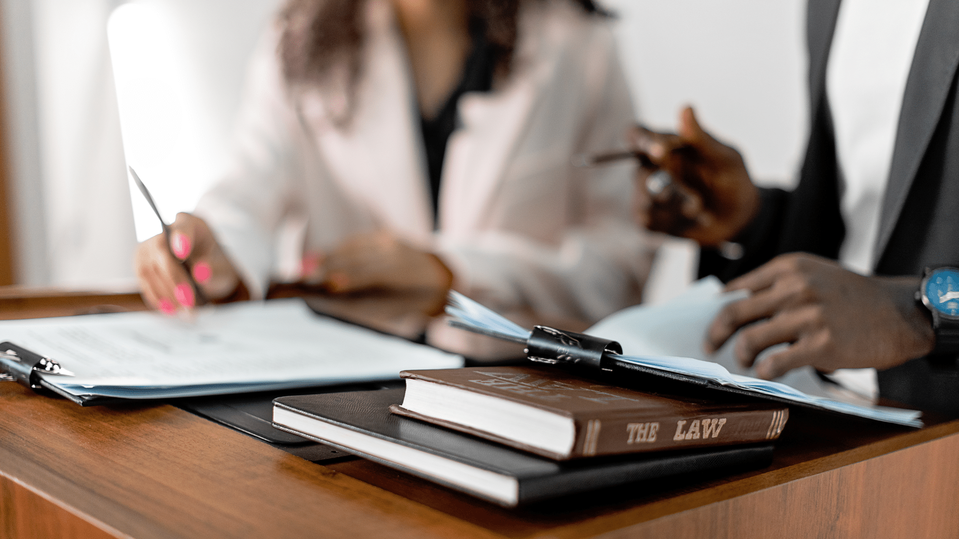 An image of two small business owners who are reviewing the 2025-2026 Employment Law Updates Employers Should Know