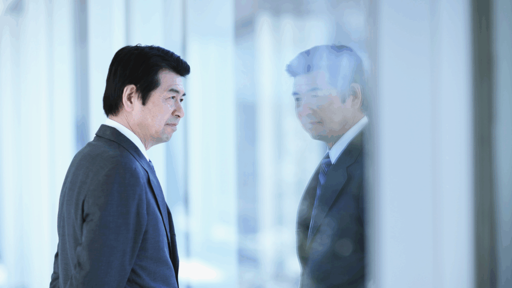 An image of a business owner in London Ontario staring out the window, contemplating succession planning for his company