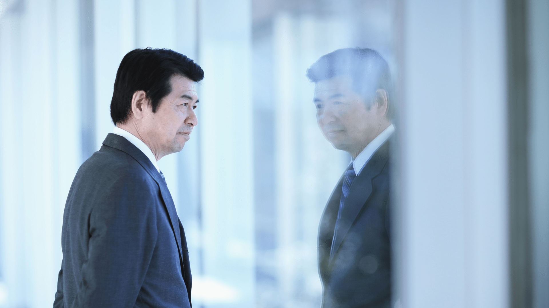 An image of a business owner in London Ontario staring out the window, contemplating succession planning for his company