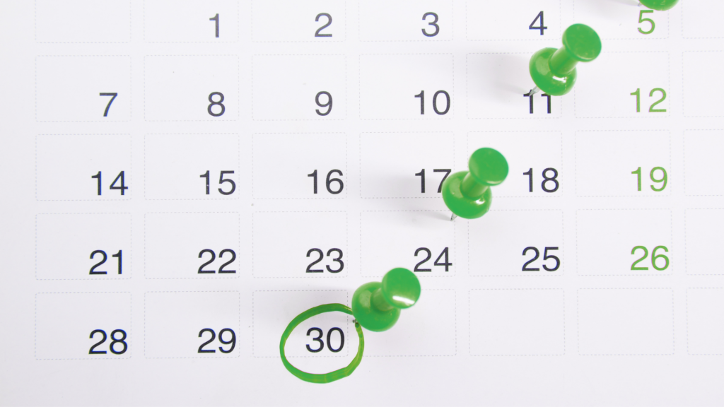 An image of a calendar with some Ford Keast LLP green pins stuck in it and the date 30 circled in green.