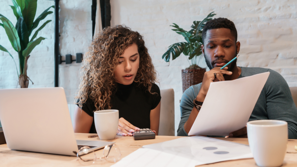 An image of a small business owner and her partner reviewing their financials and budgeting for the upcoming year.