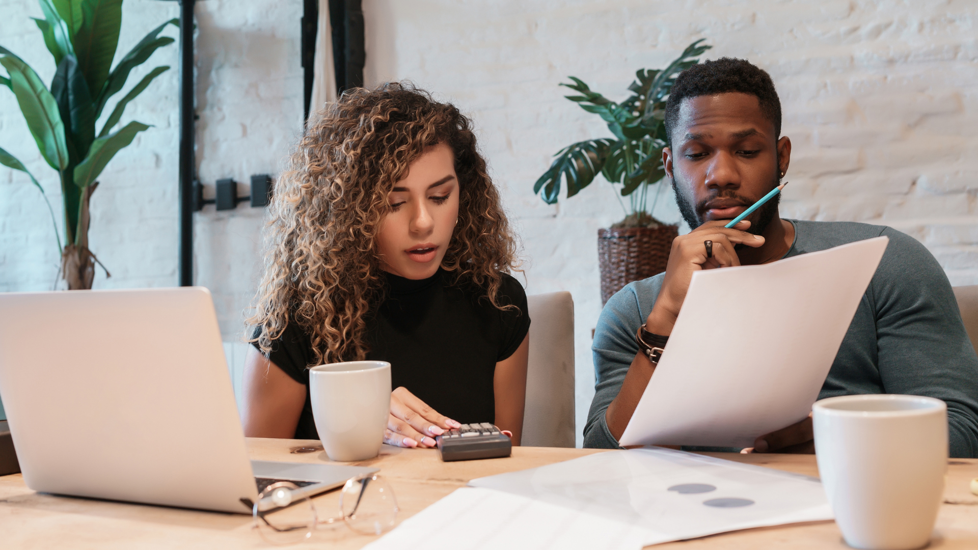 An image of a small business owner and her partner reviewing their financials and budgeting for the upcoming year.